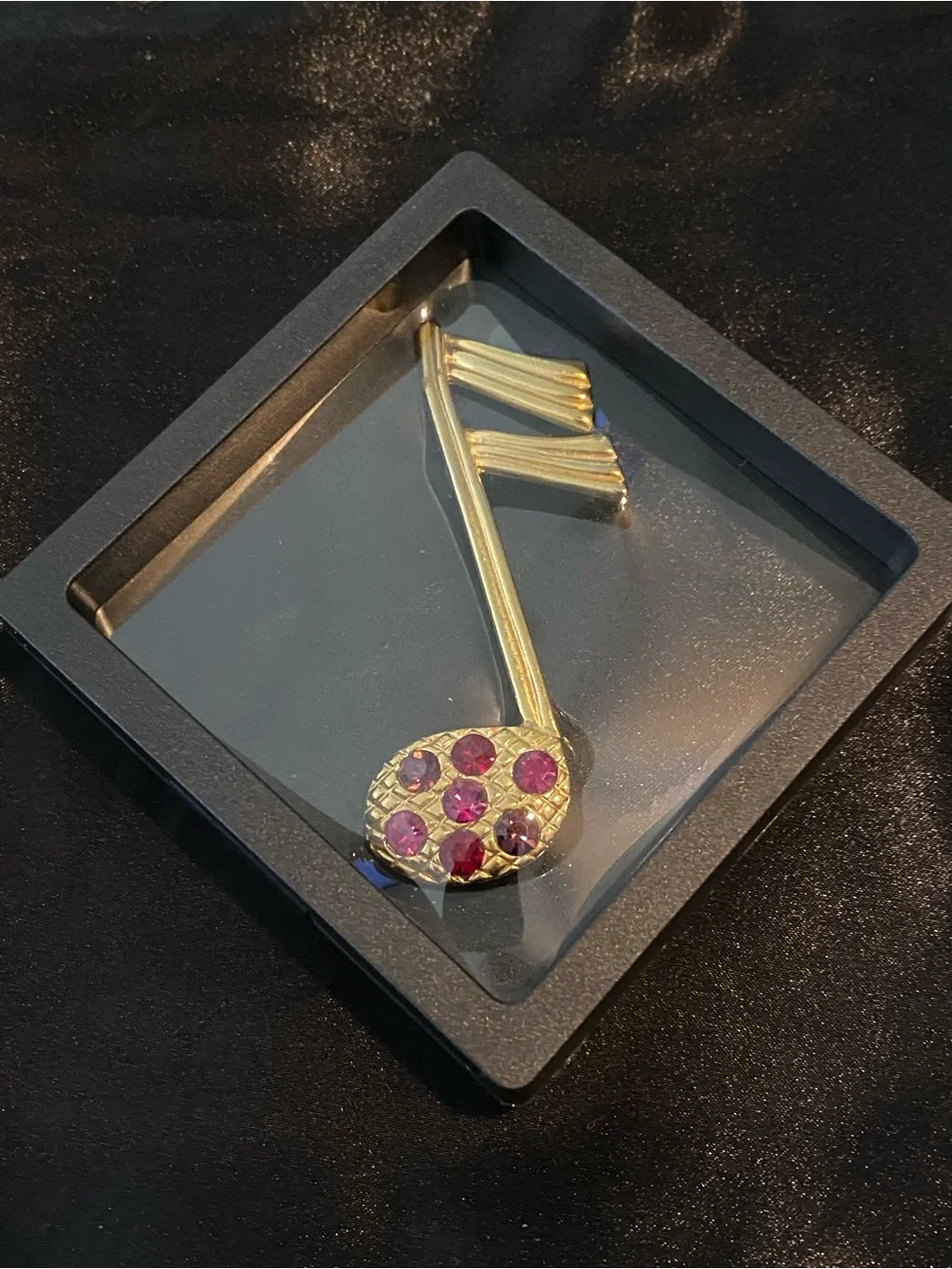 Gold-Tone Musical Note Brooch with Pink & Red Stones